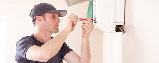 Heat Pumps and Air Conditioning Auckland and Waiheke Island- Technician Installs Air Conditioner